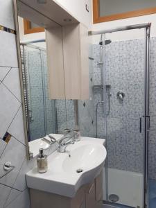 a bathroom with a sink and a shower at Barone Blu in Salerno