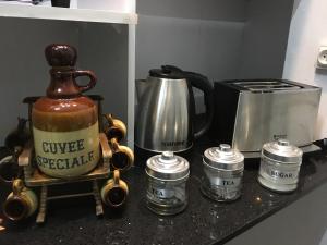 a counter with a coffee maker and a coffeespeaker at The Octagon wing A in Beau Vallon