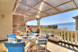 a dining room with a table and chairs on a balcony at Bayview Apartments in Tivat