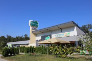 a hospital building with an umbrella in front of it at Hotel Draganic in Draganići