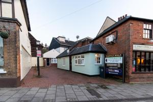 a group of buildings on a city street at Spacious 2BR Flat in Stansted in Stansted Mountfitchet