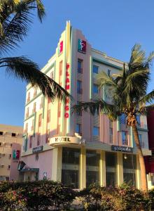 a hotel with palm trees in front of it at Flamingo Hotel in Jeddah