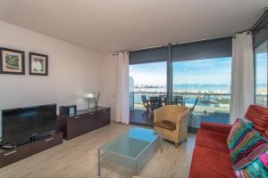 A television and/or entertainment centre at Costabravaforrent Balco 2