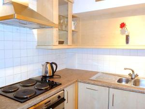 a kitchen with a stove top oven next to a sink at Elegant Fitzrovia 2-bed w Wifi: Close to Oxford Street W1 in London
