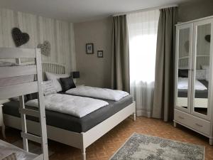 a bedroom with two bunk beds and a window at Artha Apartments Rust - Europa-Park in Rust