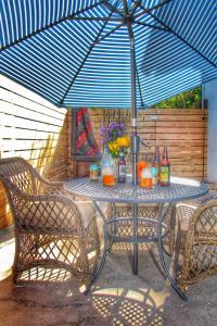 een tafel met een blauwe parasol op een patio bij Downtown Urban Flat - close to SMART Station in Santa Rosa