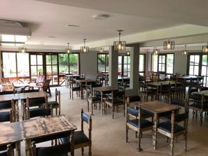 a dining room with tables and chairs and windows at Hotel Savoia Ostende in Ostende