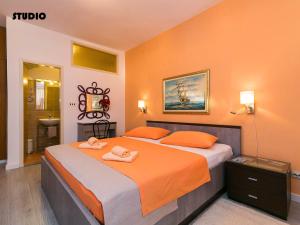 a bedroom with a bed with two towels on it at Apartments Nives in Poreč