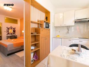 mały apartament z łóżkiem i kuchnią w obiekcie Apartments Nives w Poreču