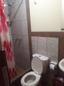 a bathroom with a toilet and a sink at El Marquez in Tacna