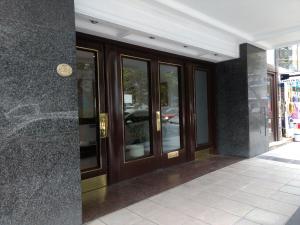 a facade of a building with glass doors at Hispano in Mar del Plata