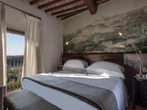 A bed or beds in a room at Castel Monastero - The Leading Hotels of the World