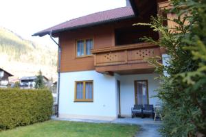a house with a balcony on the side of it at GRIASS EICH Ski-to-door Apartment by Isa Badkleinkirchheim in Bad Kleinkirchheim