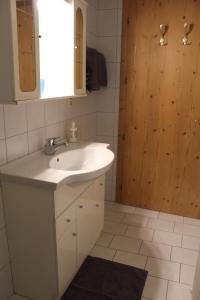 a bathroom with a white sink and a mirror at Ferienwohnung Claudia in Fügenberg
