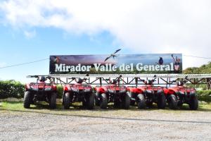 a group of four atvs parked under a billboard at Mirador Valle del General in La Ese