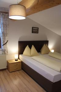 a bedroom with a large bed with two pillows at Ferienwohnung Claudia in Fügenberg