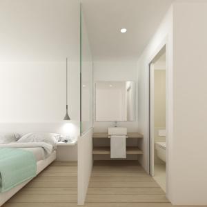 a bedroom with a bed and a sink and a mirror at Hotel hcp in Calella de Palafrugell
