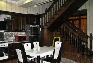 a kitchen with a table and chairs and a staircase at Like Guest House in Samarkand +10 photos