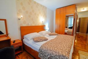a bedroom with a bed with two pillows on it at Hotel Mod in Sarajevo