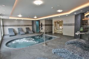 a jacuzzi tub in a hotel room at Frensham Pond Country House Hotel & Spa in Farnham