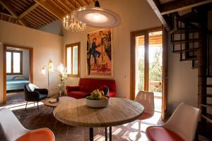 a living room with a table and a red couch at Tuscany Forever Apartments 2 in Volterra