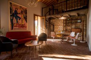 a living room with a couch and chairs and a table at Tuscany Forever Apartments 2 in Volterra