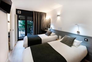 Cama o camas de una habitación en Hotel Mila