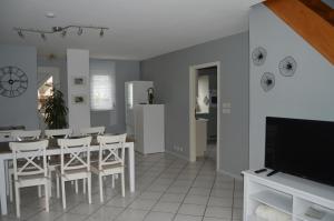 a kitchen and dining room with a table and chairs at Au Pays de la Potasse in Ungersheim