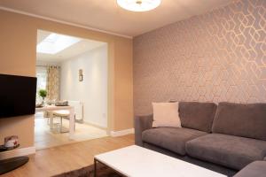 a living room with a couch and a table at Oxford City Boutique Home: "Oxford Collegiate Residence by AHG" in Oxford