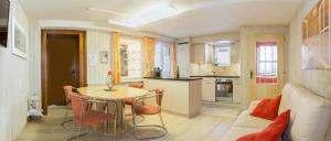 a kitchen and living room with a table and chairs at Chalet Heimetli in Grächen