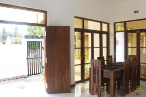 a dining room with a table and some glass doors at Ever Green Villa in Negombo