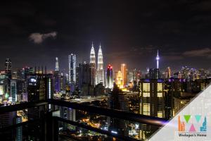 a view of a city skyline at night at Expressionz KLCC by Wodages in Kuala Lumpur