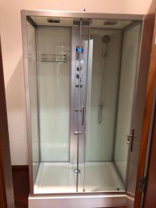 a shower with a glass door in a bathroom at Metro Heroismo Residence in Porto +63 photos