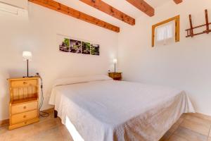 A bed or beds in a room at Villa Es Coste Rafal By SunVillas Mallorca