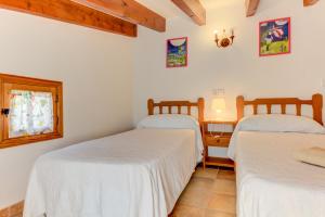 A bed or beds in a room at Villa Es Coste Rafal By SunVillas Mallorca