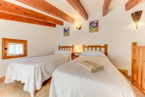 A bed or beds in a room at Villa Es Coste Rafal By SunVillas Mallorca
