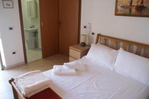 a bedroom with a bed with two towels on it at Apricot House in Roccascalegna