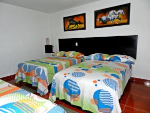 מיטה או מיטות בחדר ב-Hotel Sucre Del Bosque