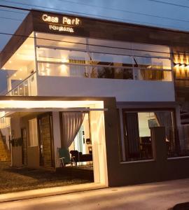 a building with a sign that reads class rock tourism at Pousada CasaPark in Penha