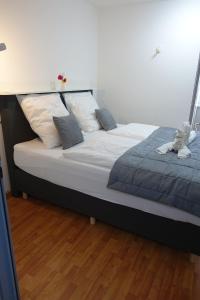 ein großes Bett in einem Zimmer mit Holzboden in der Unterkunft Stern Hotel in Leipzig