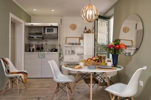 a kitchen and dining room with a table and chairs at Artemis Apartment in Corfu Town