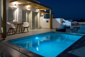 a swimming pool in a villa at night at Aeris suites in Koufonisia