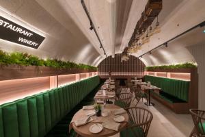 a restaurant with tables and chairs in a tunnel at Boutique hotel Tvrđa in Osijek