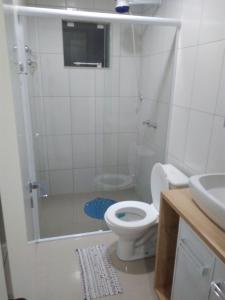 y baño con ducha, aseo y lavamanos. en Residencial Saul Bertemes, en Bombinhas
