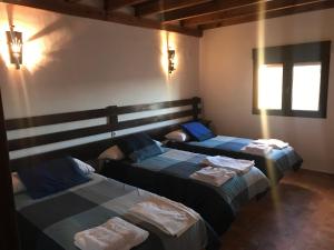 Giường trong phòng chung tại VTAR Don Benito, su casa rural en Gilena