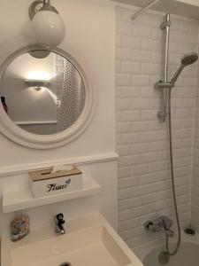 a bathroom with a sink and a mirror at Apartment Thalassa in Blankenberge