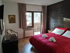 Postel nebo postele na pokoji v ubytování Hotel I Larici