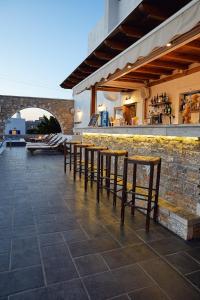 a group of tables and chairs on a patio at Vigla Hotel in Aegiali
