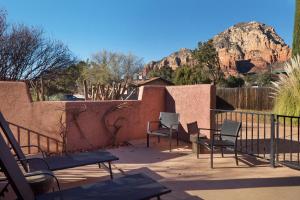 a patio with chairs and a fence and a mountain at Luxurious Red Rock Vista Villa in Sedona