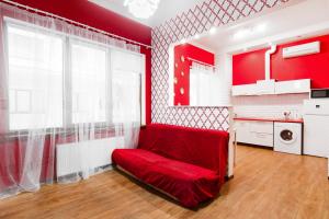 a red room with a red couch in a kitchen at Modern Apartment in the city center in a new building in Odesa
